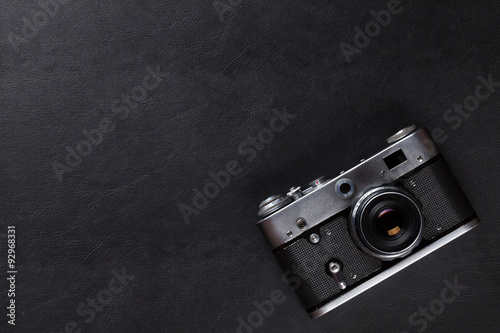 Vintage film camera over leather desk table