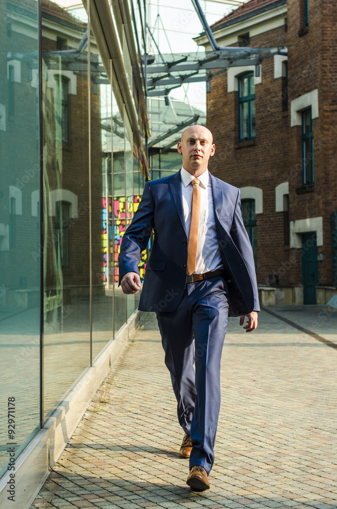 Young business man walking on the street Young business man walking on the street