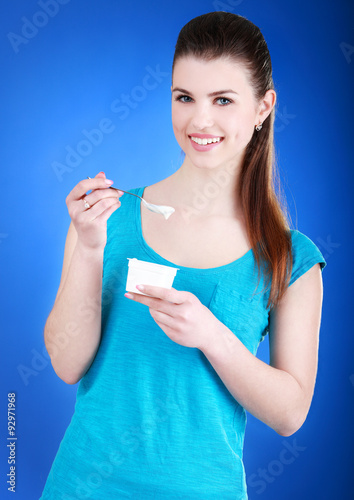 Young woman eating yogurt as breakfast or snack © azhurfoto