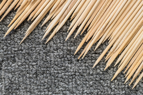Wood stick for meatball skewers with gray carpet texture background