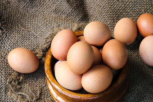 Fresh raw group of eggs put on old sack