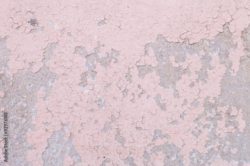 Closeup pale color and peeling of painted pink cement wall texture background