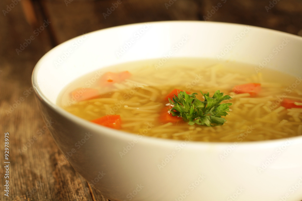 Chicken and noodles soup with carrots and parley