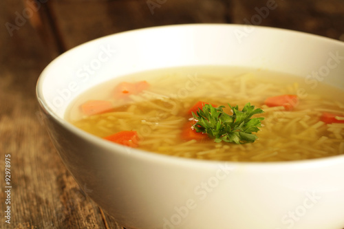 Chicken and noodles soup with carrots and parley