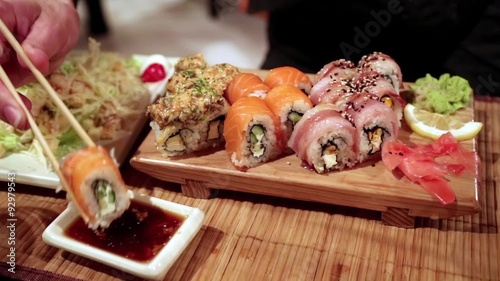 Woman eating sushi in a restaurant photo