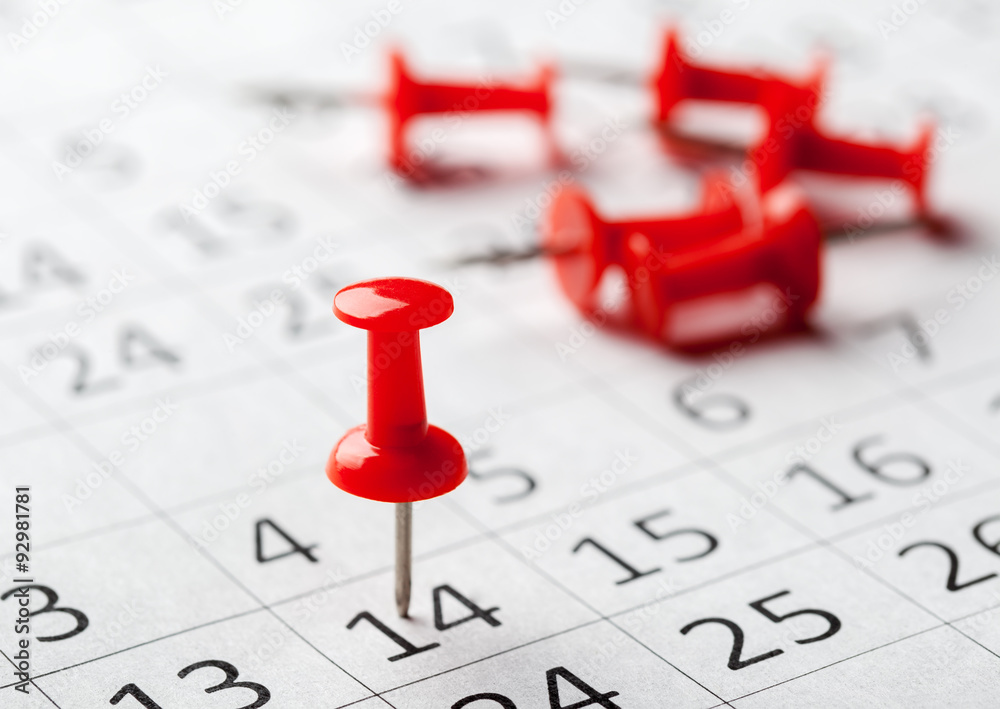 Concept image of a calendar with red push pins Concept image of a calendar with red push pins