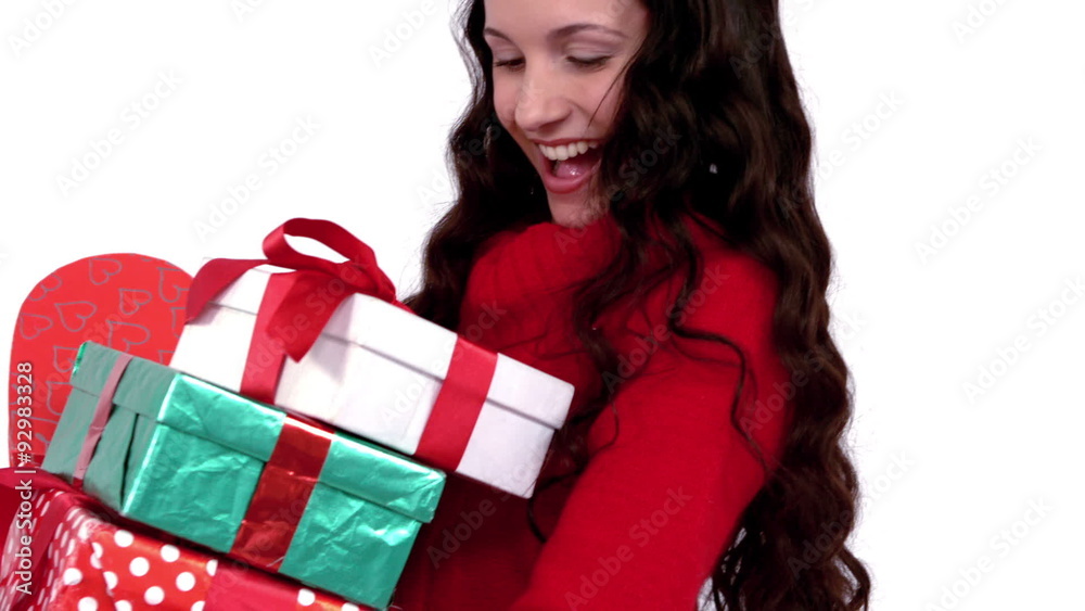 Festive brunette carrying pile of gifts Festive brunette carrying pile of gifts