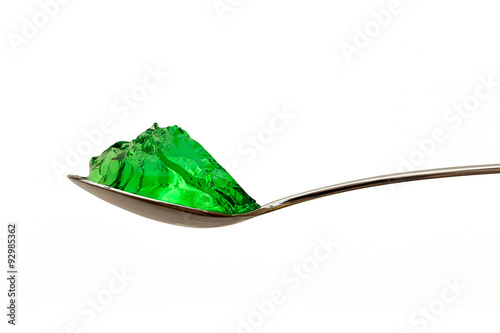 grenn jello on teaspoon isolated photo