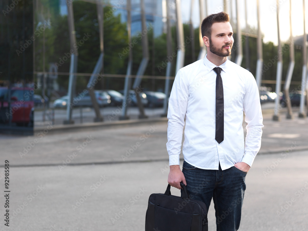 Friendly and smiling handsome businessman looking confidently Friendly and smiling handsome businessman looking confidently