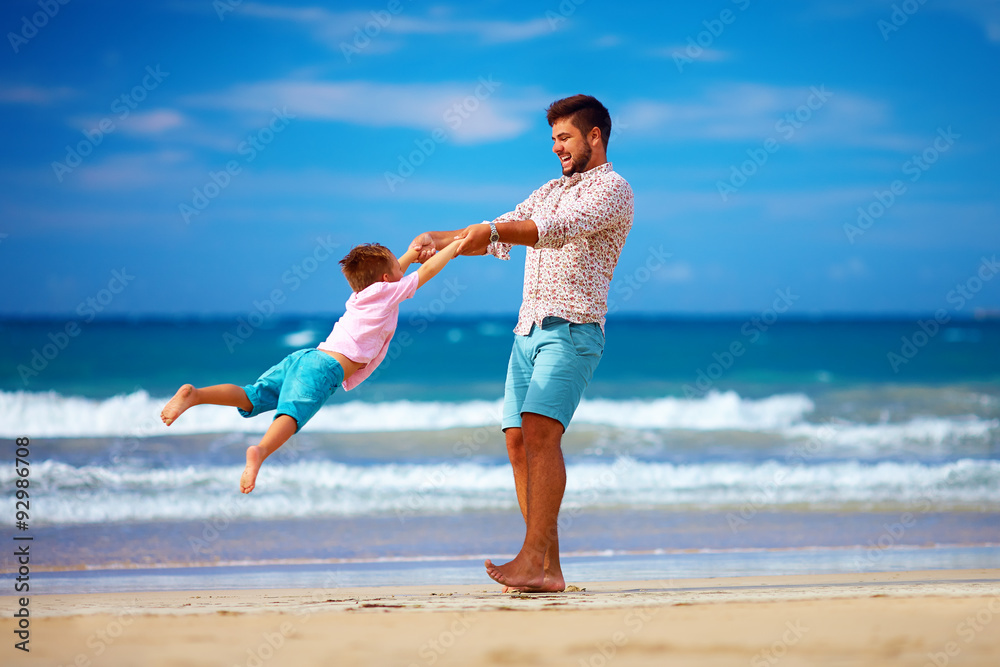 happy excited father and son having fun on summer beach, enjoy life happy excited father and son having fun on summer beach, enjoy life