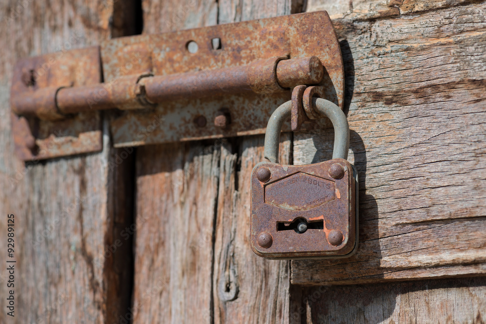 Old rusted padlock, reliable or unreliable, safety concept, made in Germany Old rusted padlock, reliable or unreliable, safety concept, made in Germany