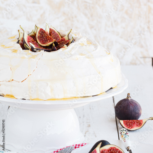 Pavlova with figs and whipped cream photo