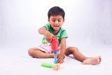 little asian boy play toy tool plastic on white background