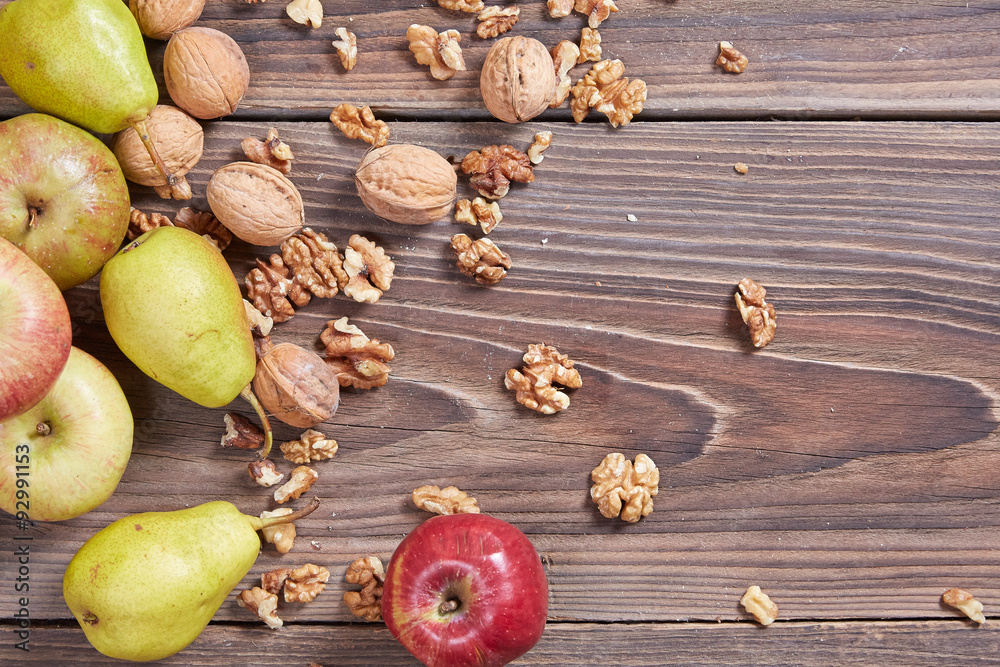 Apples and nuts on a wooden table