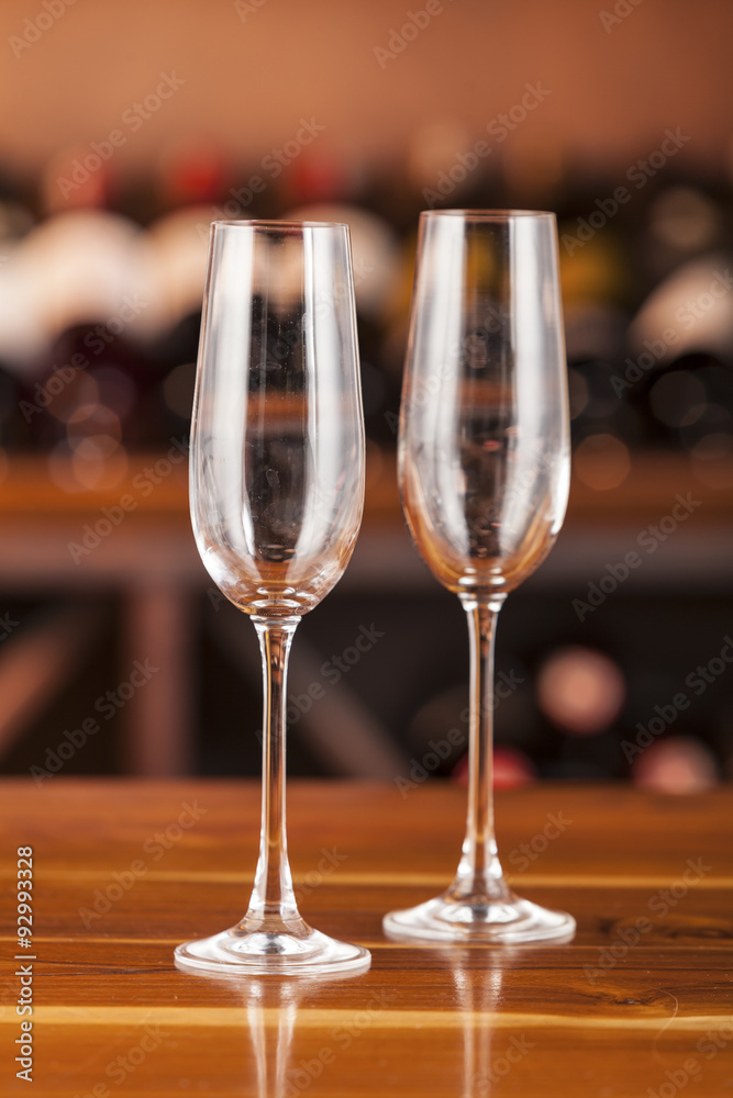 two empty glasses in background with bottles of wine two empty glasses in background with bottles of wine