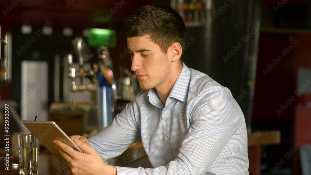 Man using tablet at the bar Man using tablet at the bar