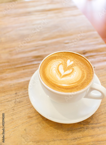 Cup of coffee latte art on wood table