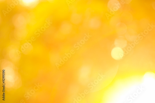 Gold glitter sparkle defocused rays lights bokeh abstract background.