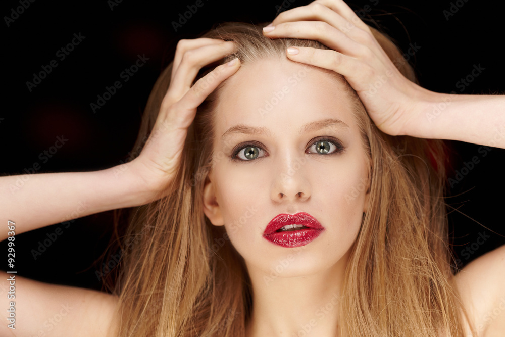 Fototapeta premium Woman with long blond hait and red lips.