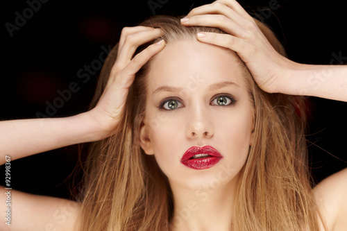  Woman with long blond hait and red lips.