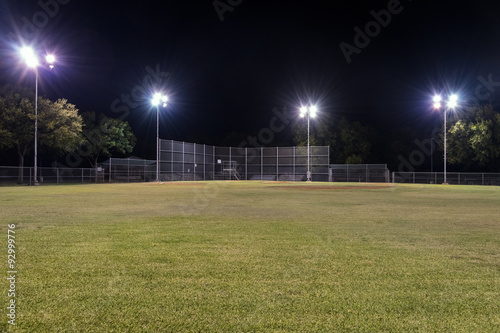 Empty baseball field at night with the lights on © Stretch Clendennen