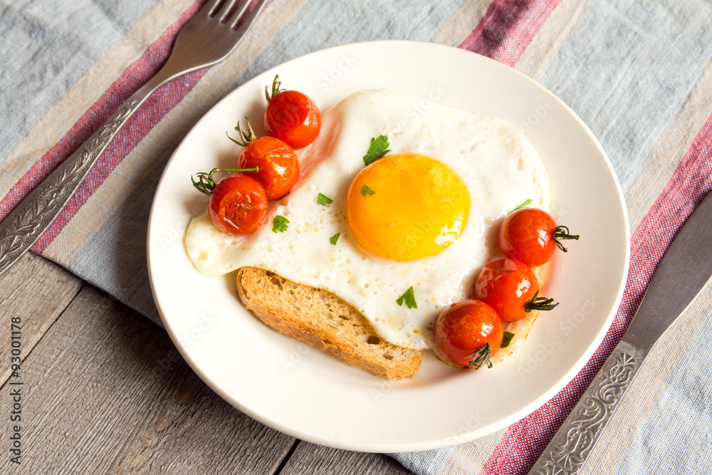 Fried egg on bread and tomatoes Fried egg on bread and tomatoes