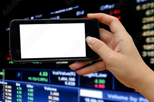 blur hand holding mobile phone on blur perspective stock market