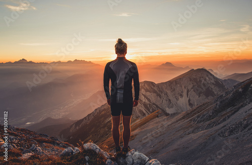 Male hiker observing the sunset at the top of the local big mountain. The photograph was taken in Karavanke mountain range in Slovenia.