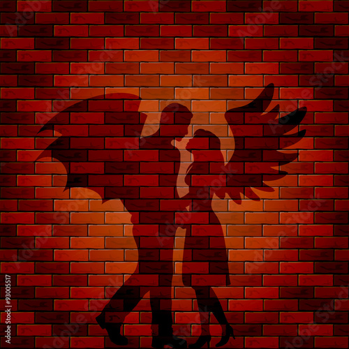 Shadow of angel and demon on brick wall