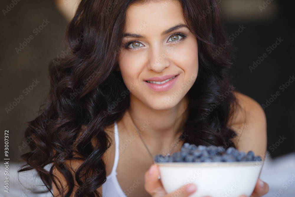 Home portrait of a happy woman with ripe berries Home portrait of a happy woman with ripe berries