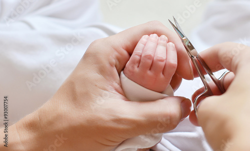 cutting newborn baby nails with scissors