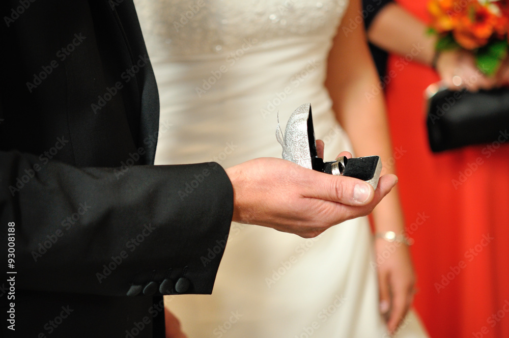 Closeup photo of bride and groom, he is holding open box with we Closeup photo of bride and groom, he is holding open box with we