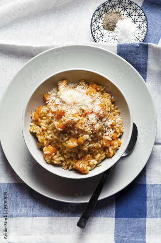 risotto with pumpkin on a blue tablecloth. and spices