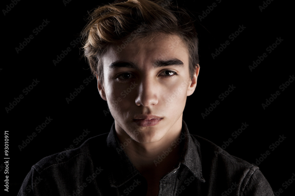 portrait of a young handsome man on black background