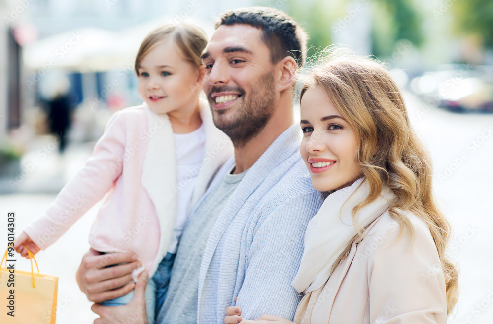 happy family with child and shopping bags in city