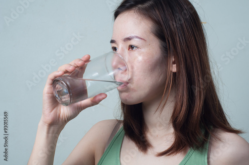 Portrait of Asian women in a green shirt are drinking water from