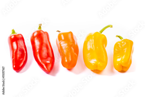 Obraz na płótnie Red, yellow and orange pepper on white background w salonie