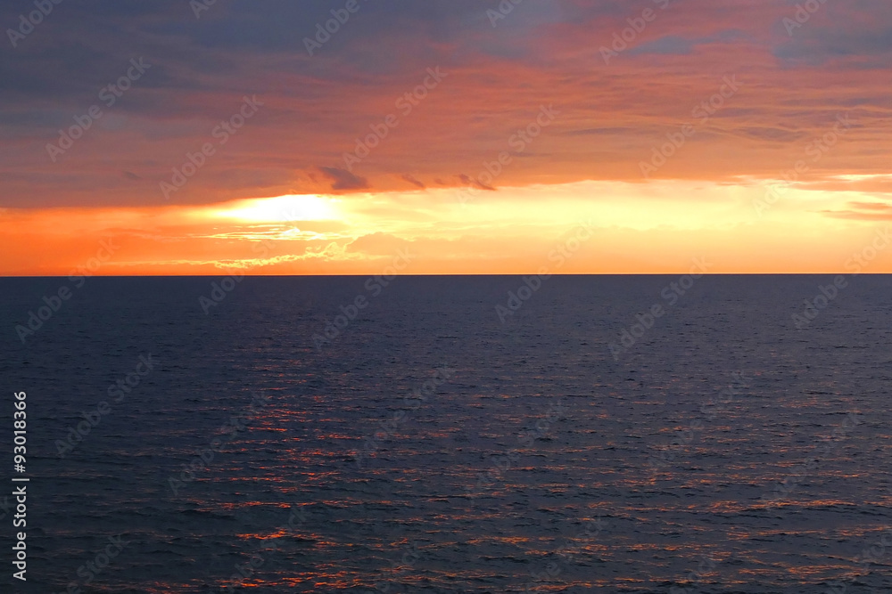 Sunset over the sea, the ocean evening, the skyline is endless, horizon of water, the red sunset.
