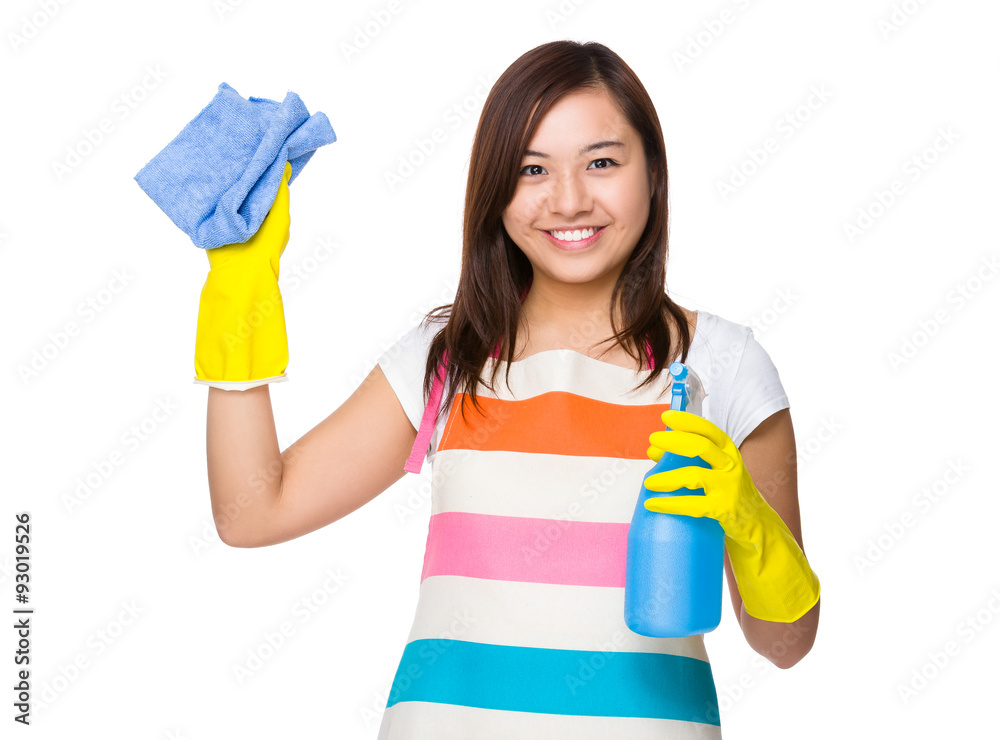 Housewife using rag and bottle spray Housewife using rag and bottle spray