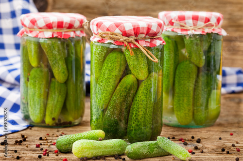 Jars of canned pickles with peppers