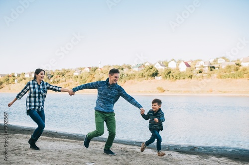 vacation young family near the lake, happy father, mother and so