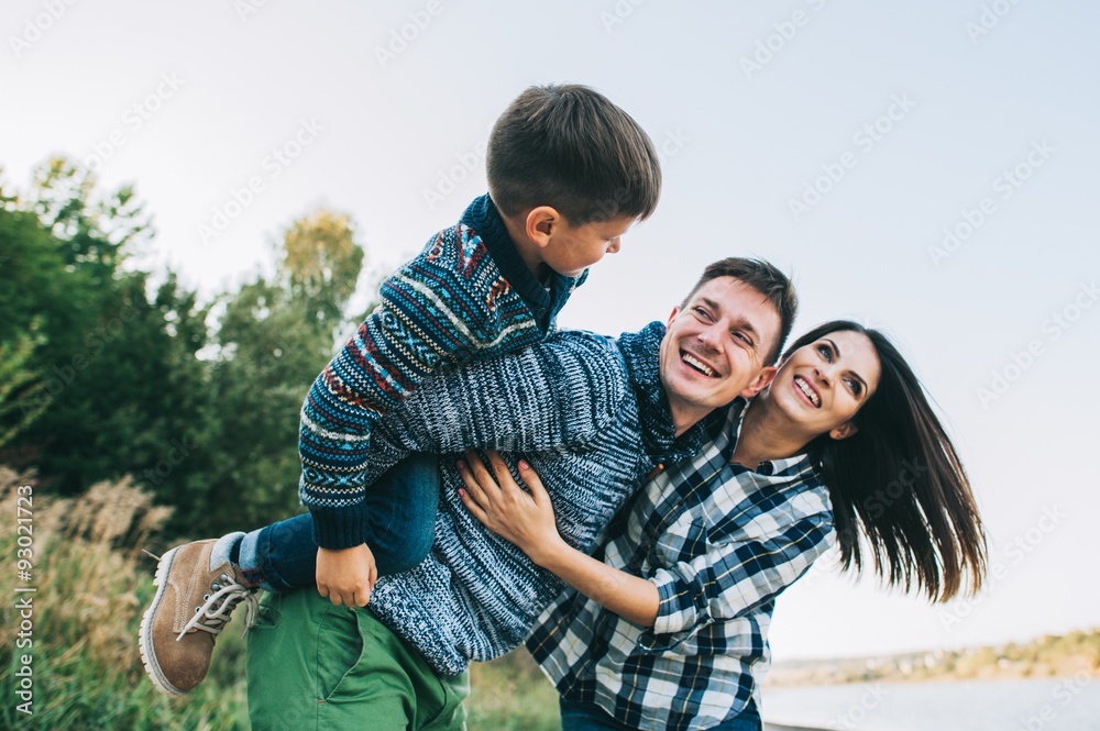 Fototapeta premium vacation young family near the lake, happy father, mother and so