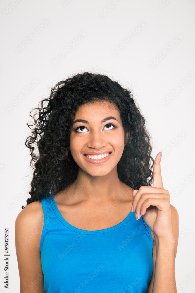 Afro american woman pointing finger up at copyspac Afro american woman pointing finger up at copyspac