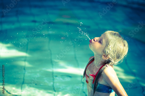 child spitting water photo