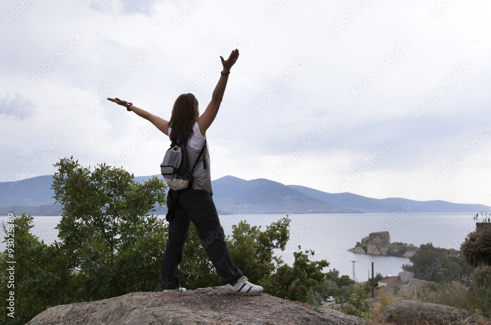Healthy and happy young woman greets the mountain and sea Healthy and happy young woman greets the mountain and sea