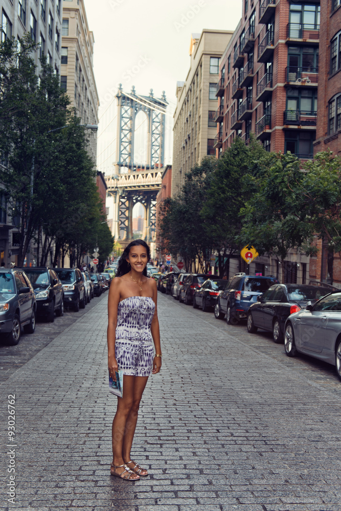 Female tourist standing in a NYC back street