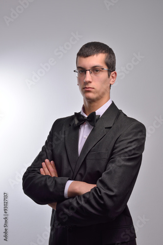 Portrait of young business man with arms crossed