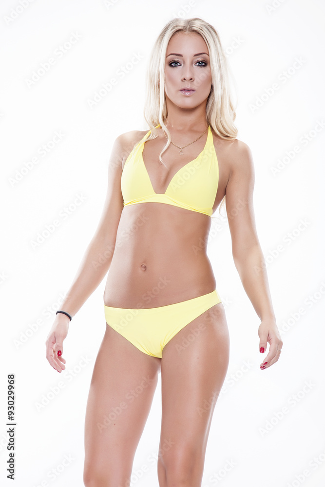 Sexy blonde woman wearing pink swimwear posing on white backgrou Sexy blonde woman wearing pink swimwear posing on white backgrou