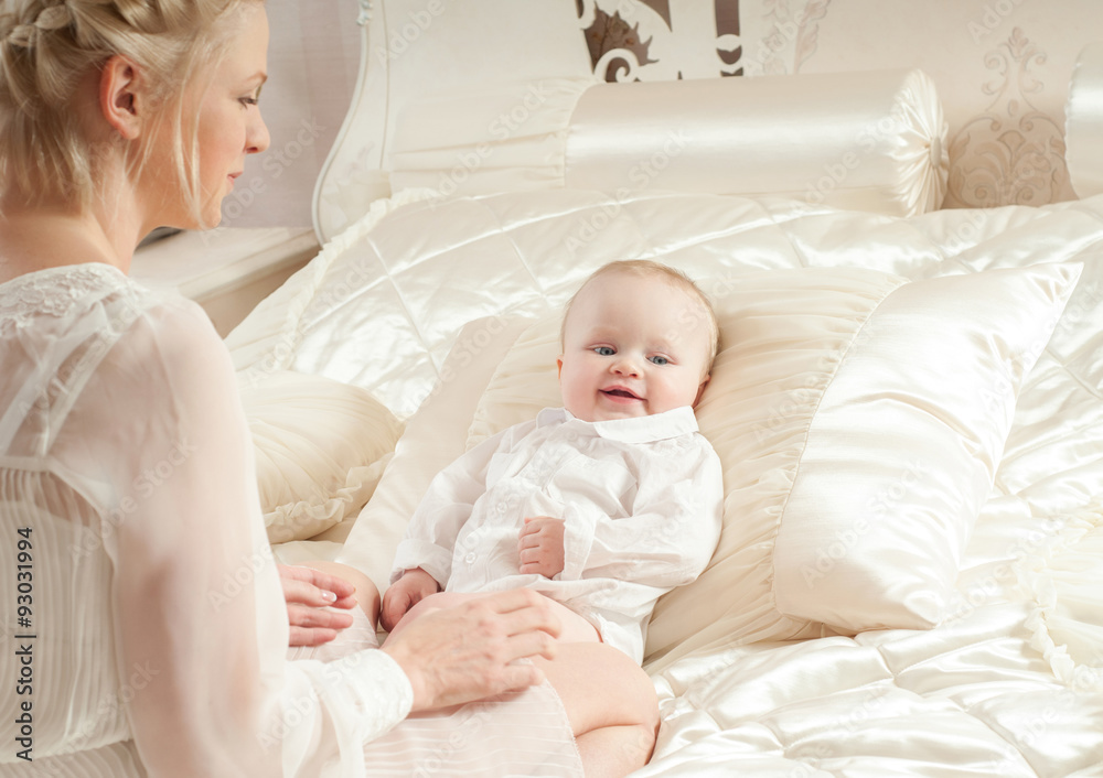 Mother and baby playing and smiling. Happy family.Home interior. Mother and baby playing and smiling. Happy family.Home interior.