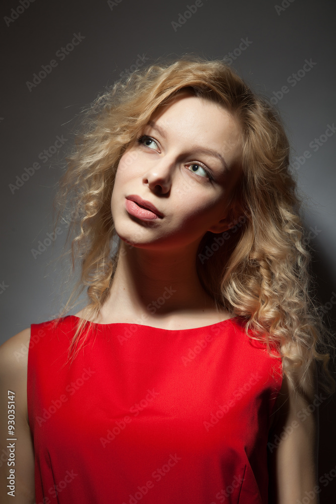 Portrait of a beautiful blonde in a red dress. Portrait of a beautiful blonde in a red dress.